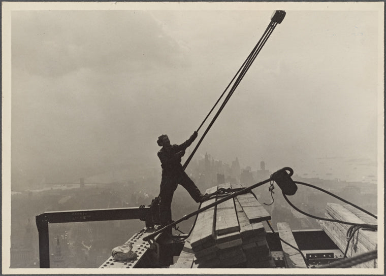 Construction worker maneuvering rope and pulley