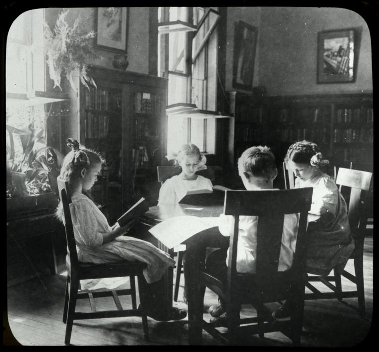 Riverside, girls sitting in a circle by a sunny window, plants nearby
