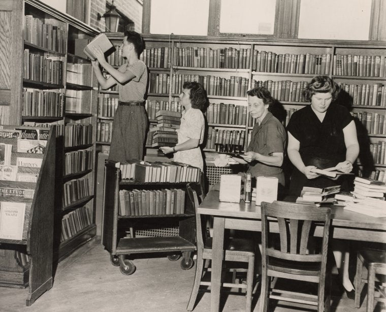 Rearranging books in Port Richmond Library