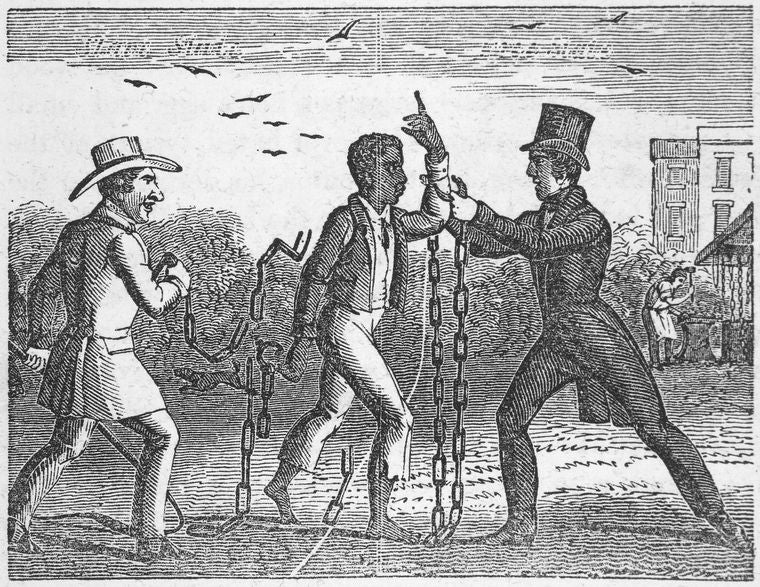 A black man with chains surrounded by two white men