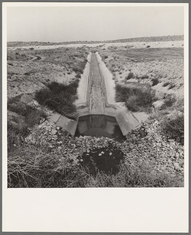 Irrigation canal. Shows drop to go under road. Water has just been shut off for the season. Near Nyssa, Malheur County, Oregon
