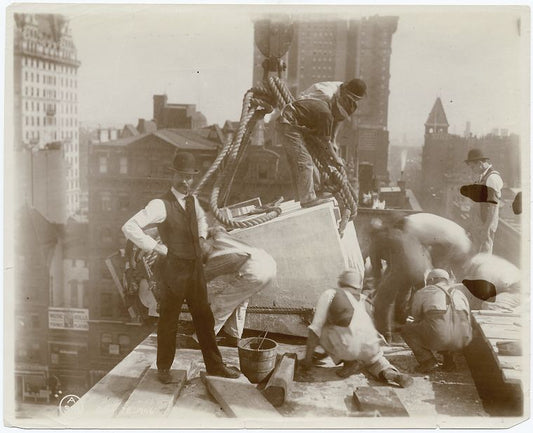 Exterior marble work : construction workers positioning a piece of marble on the roof, looking east
