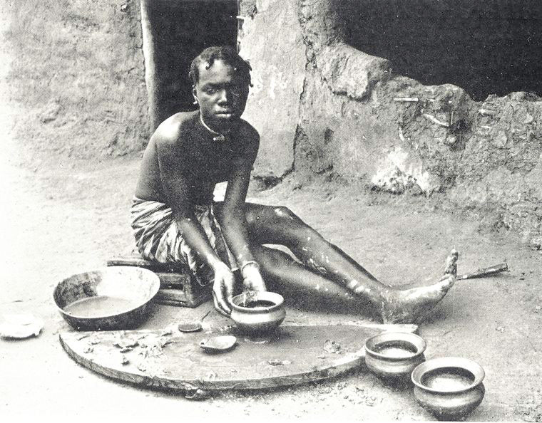 A woman making clay pots, Liberian Western Homeland.
