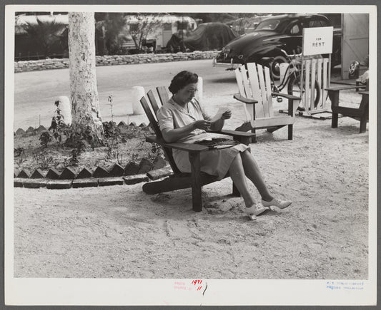 One of the occupants of Sarasota trailer park reading her mail. Sarasota, Florida.