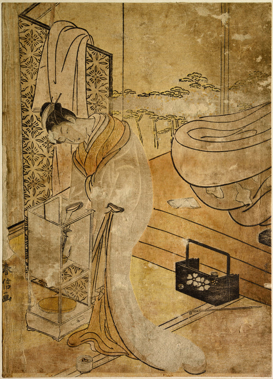 An oiran in night attire standing by an andon and trimming the lamp with a hairpin.  Back of her is her bed with futon piled on it and a tobakobon and pipe beside it.  At the left a screen with a kimono thrown over it