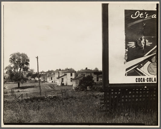 Houses with partial view of billboard advertising Coca-Cola in foreground. West Virginia?