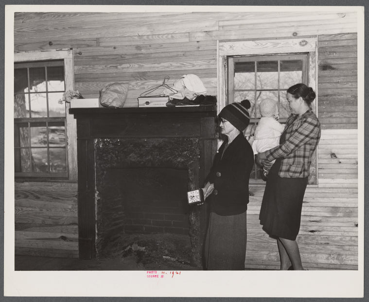 Mrs. Harvey and a neighbor watching her belongings being moved out of her house in the Camp Croft area near Whitestone, South Carolina.