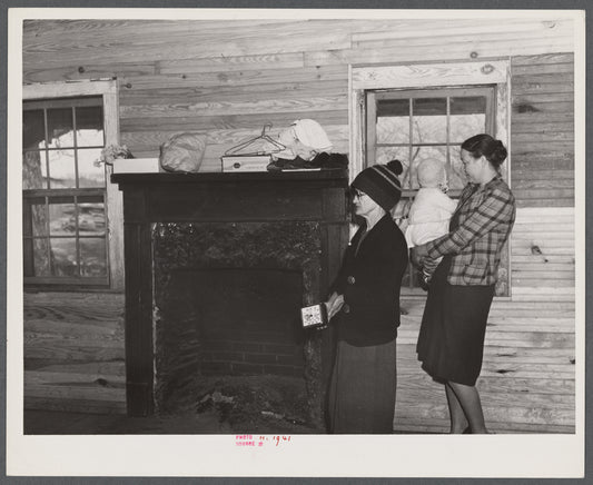 Mrs. Harvey and a neighbor watching her belongings being moved out of her house in the Camp Croft area near Whitestone, South Carolina.