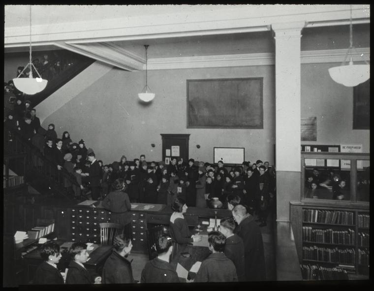 96th Street, Adult room, 1923, showing people at desk, and stairway filled with people