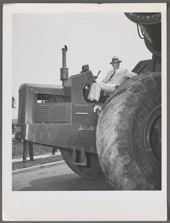 Robert Moses seated on a tractor
