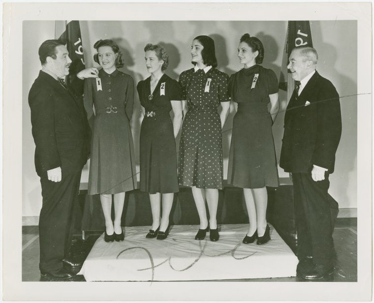 Contests - Grover Whalen pinning ribbon on woman