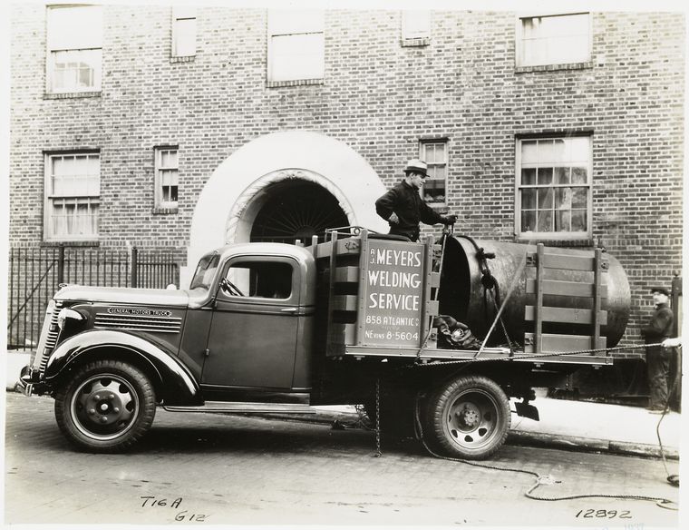 Model T 16A - G12; people working from the truck labeled A.C. Meyers Welding Service