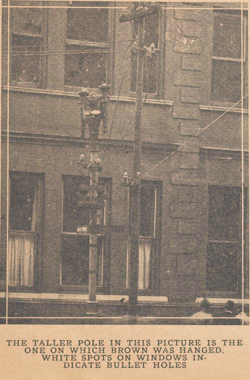 The taller pole in this picture is the one on which Brown was hanged: White spots on windows indicate bullet holes.